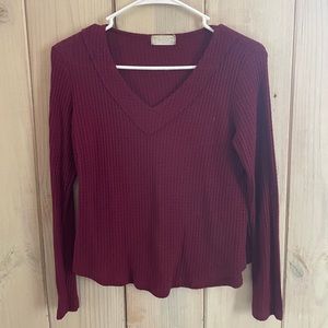 Red knitted style long sleeve shirt.